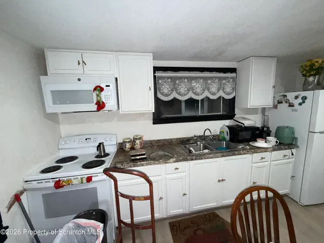 a kitchen with stainless steel appliances a sink a stove and a refrigerator