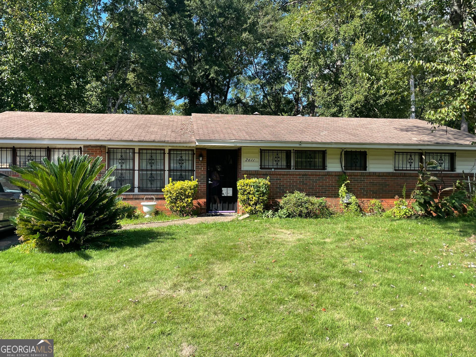 a front view of a house with garden