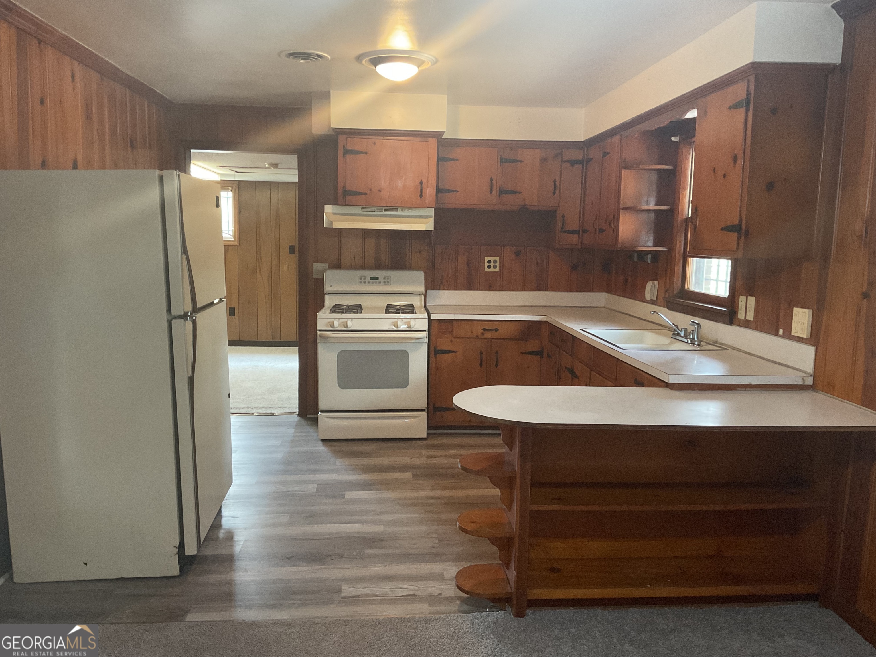 2611 Rice Street Columbus, GA 31903 - Photo 2 of 11 a kitchen with kitchen island a sink appliances and cabinets