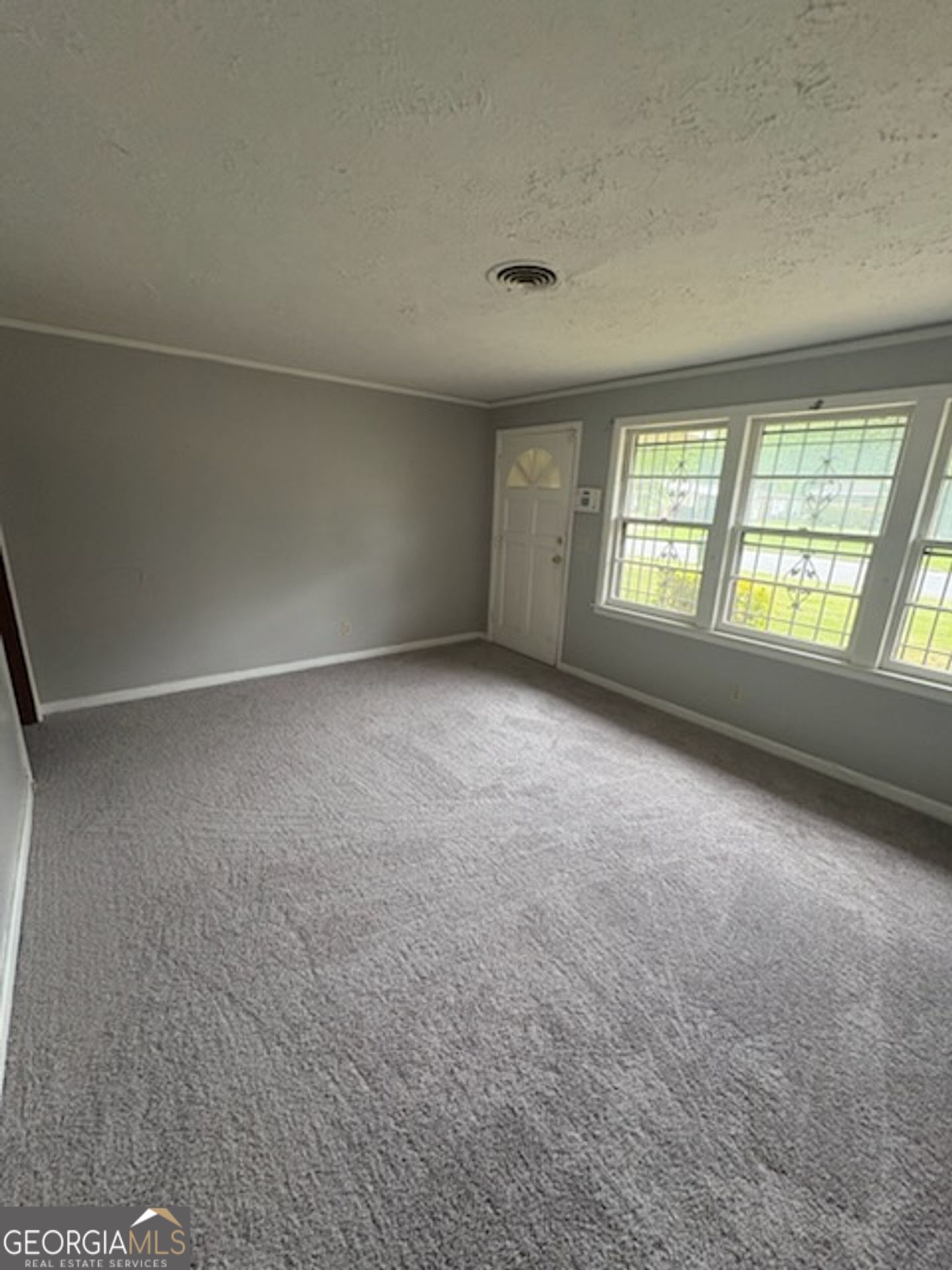 2611 Rice Street Columbus, GA 31903 - Photo 4 of 11 an empty room with windows