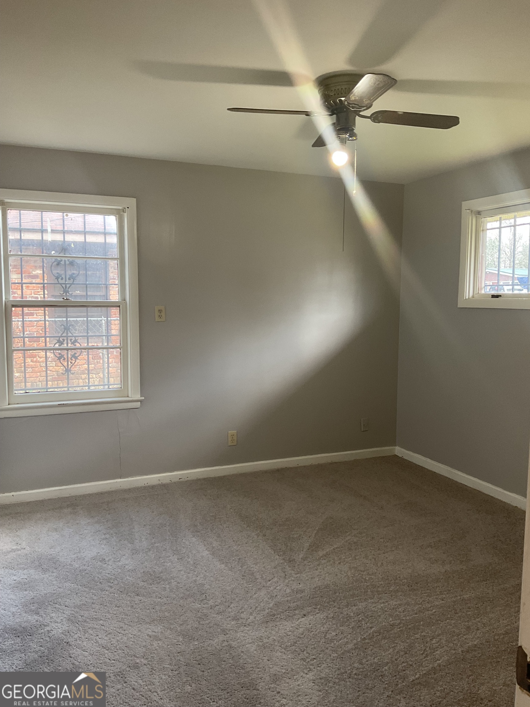 2611 Rice Street Columbus, GA 31903 - Photo 6 of 11 an empty room with windows and fan