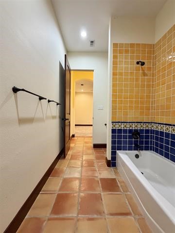 12410 Keith Road Beaumont, TX 77713 - Photo 36 of 45 a bathroom with a bathtub and a shower