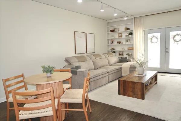 a living room with furniture a rug and a view of kitchen