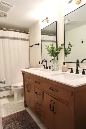 a bathroom with a double vanity sink and a mirror