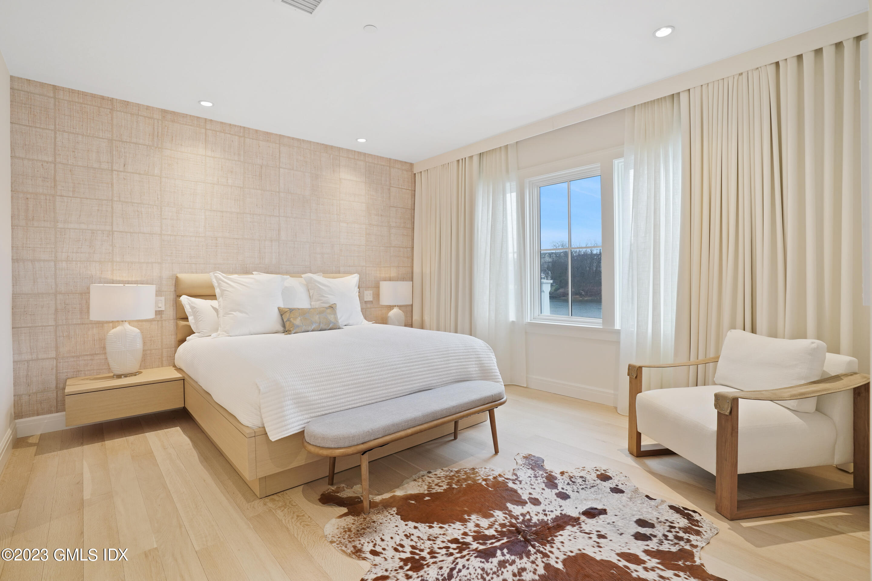 89 River Road, Unit 203 Cos Cob, CT 06807 - Photo 5 of 17 a bedroom with a bed and a couch