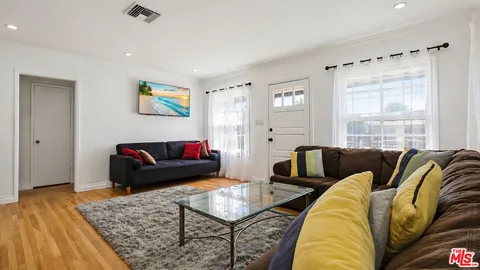 a bedroom with two beds and a dresser