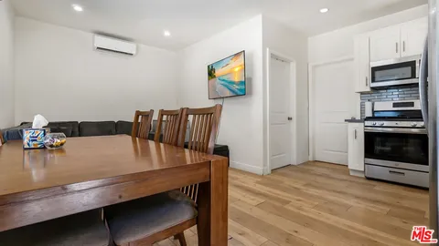 a kitchen with stainless steel appliances granite countertop a stove and a microwave
