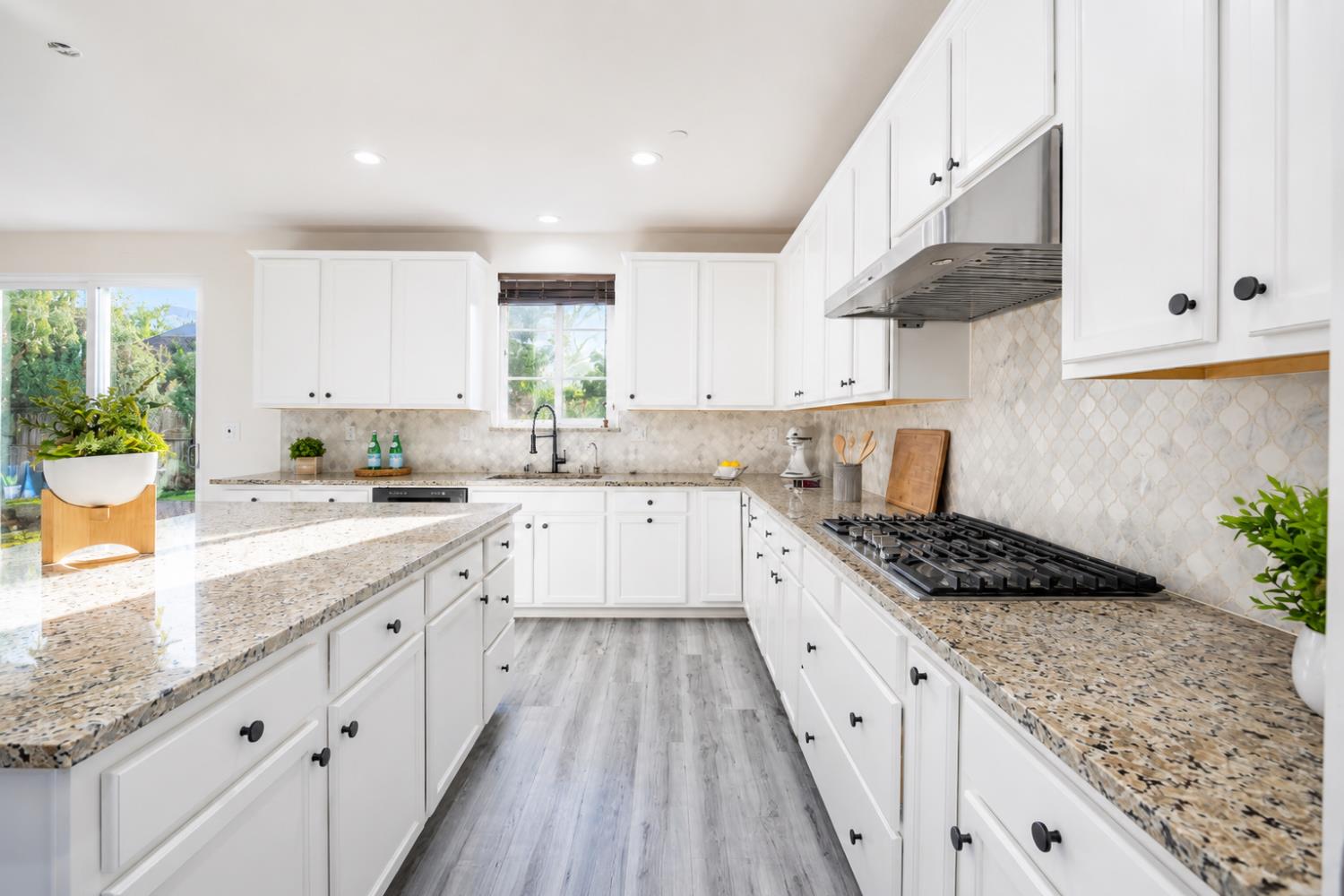 1837 South La Barbera Avenue Mountain House, CA 95391 - Photo 17 of 54 a large kitchen with stainless steel appliances granite countertop a lot of counter space and wooden floors