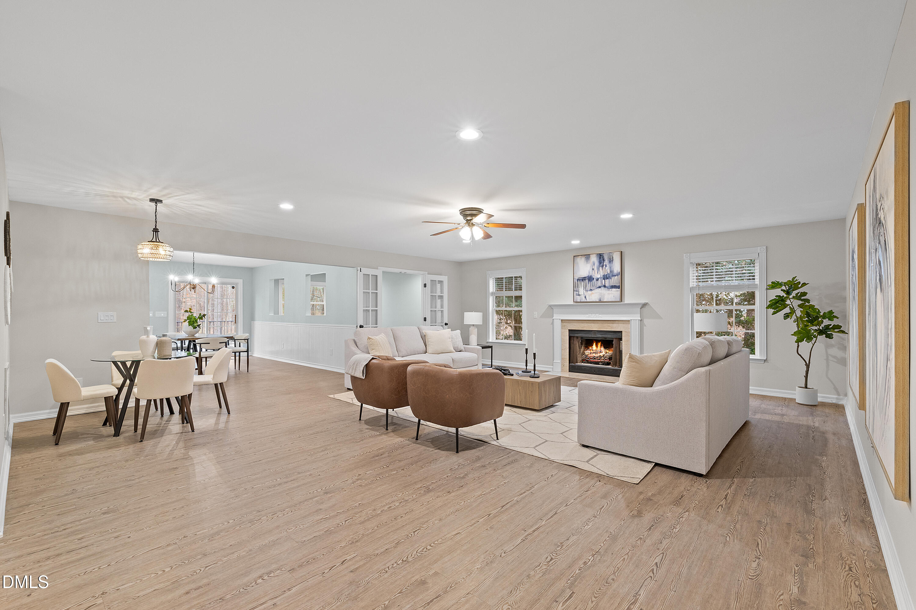 7119 Wexford Woods Trail Raleigh, NC 27613 - Photo 11 of 41 a living room with furniture a fireplace and a dining table with wooden floor