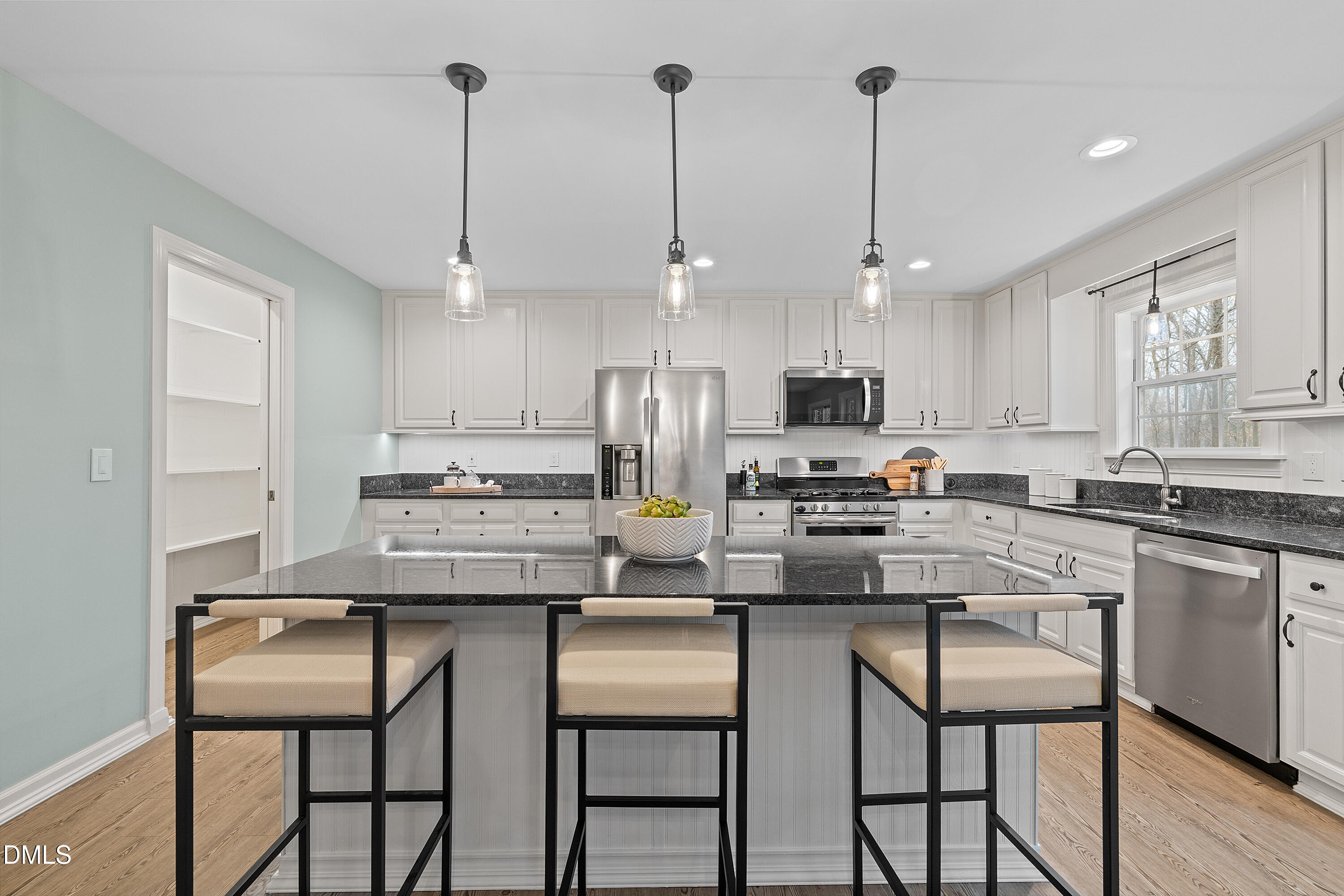 7119 Wexford Woods Trail Raleigh, NC 27613 - Photo 18 of 41 a kitchen with kitchen island granite countertop a table and chairs in it