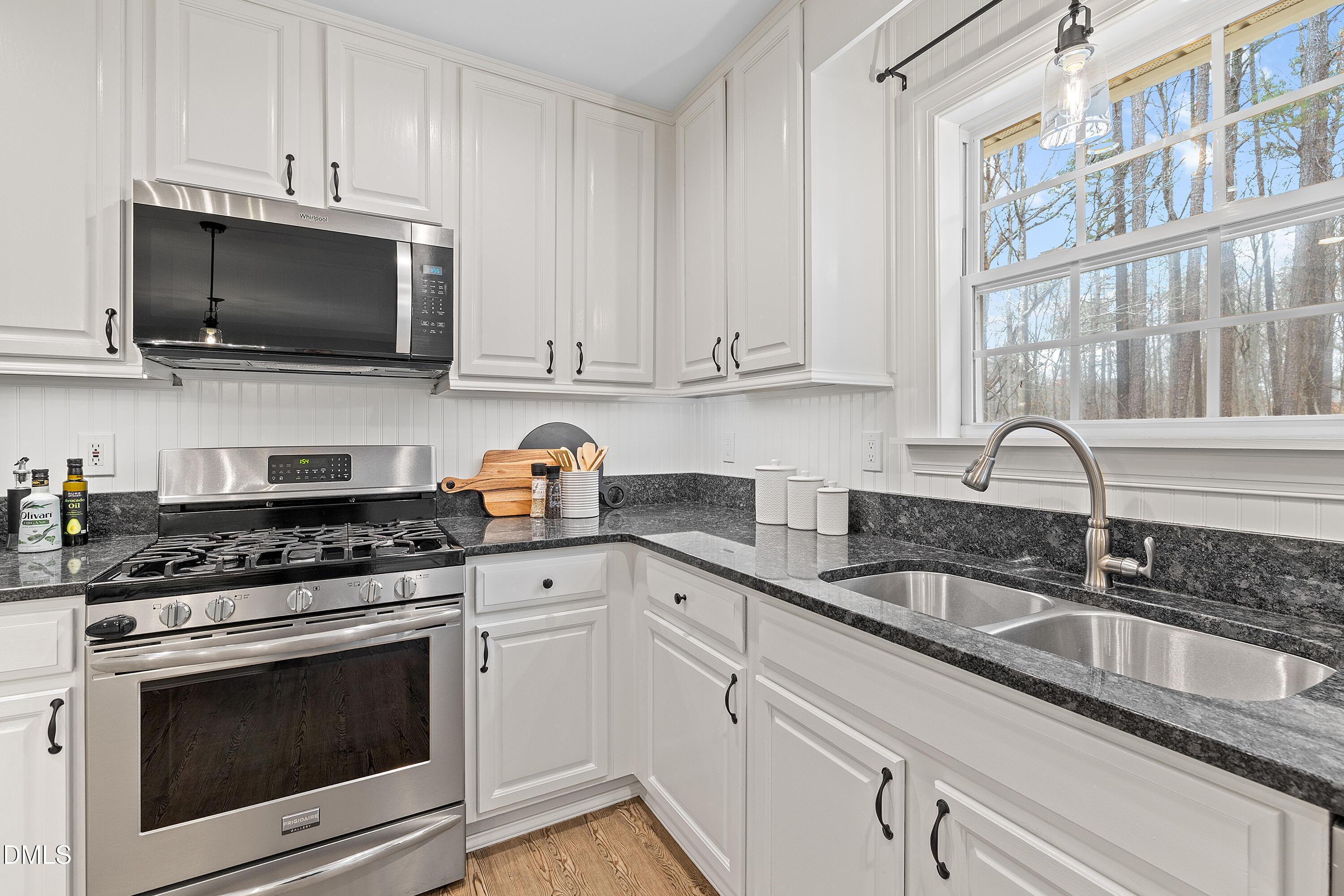 7119 Wexford Woods Trail Raleigh, NC 27613 - Photo 20 of 41 a kitchen with stainless steel appliances granite countertop white cabinets a sink and a stove