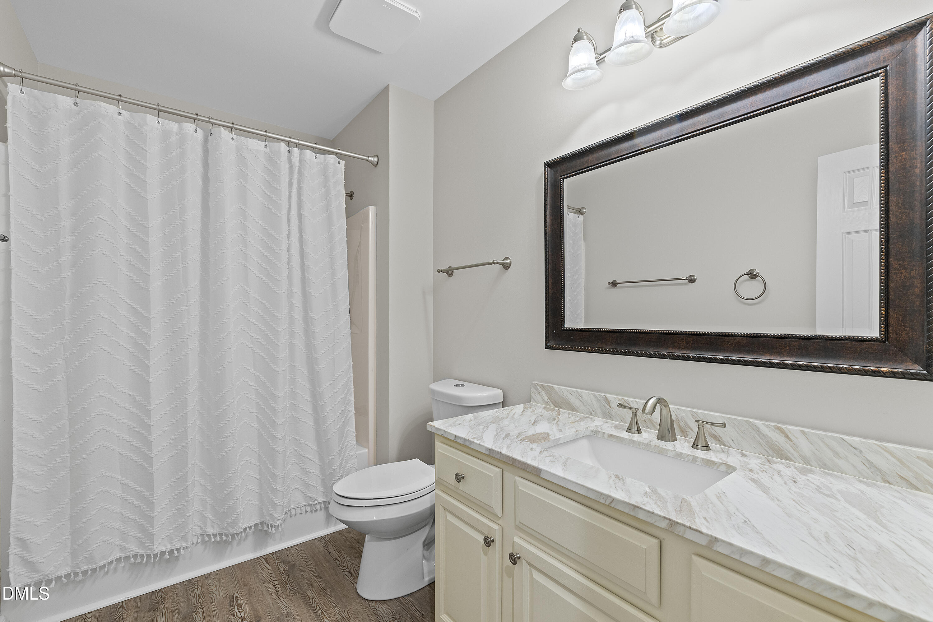 7119 Wexford Woods Trail Raleigh, NC 27613 - Photo 23 of 41 a bathroom with a granite countertop sink vanity mirror and toilet