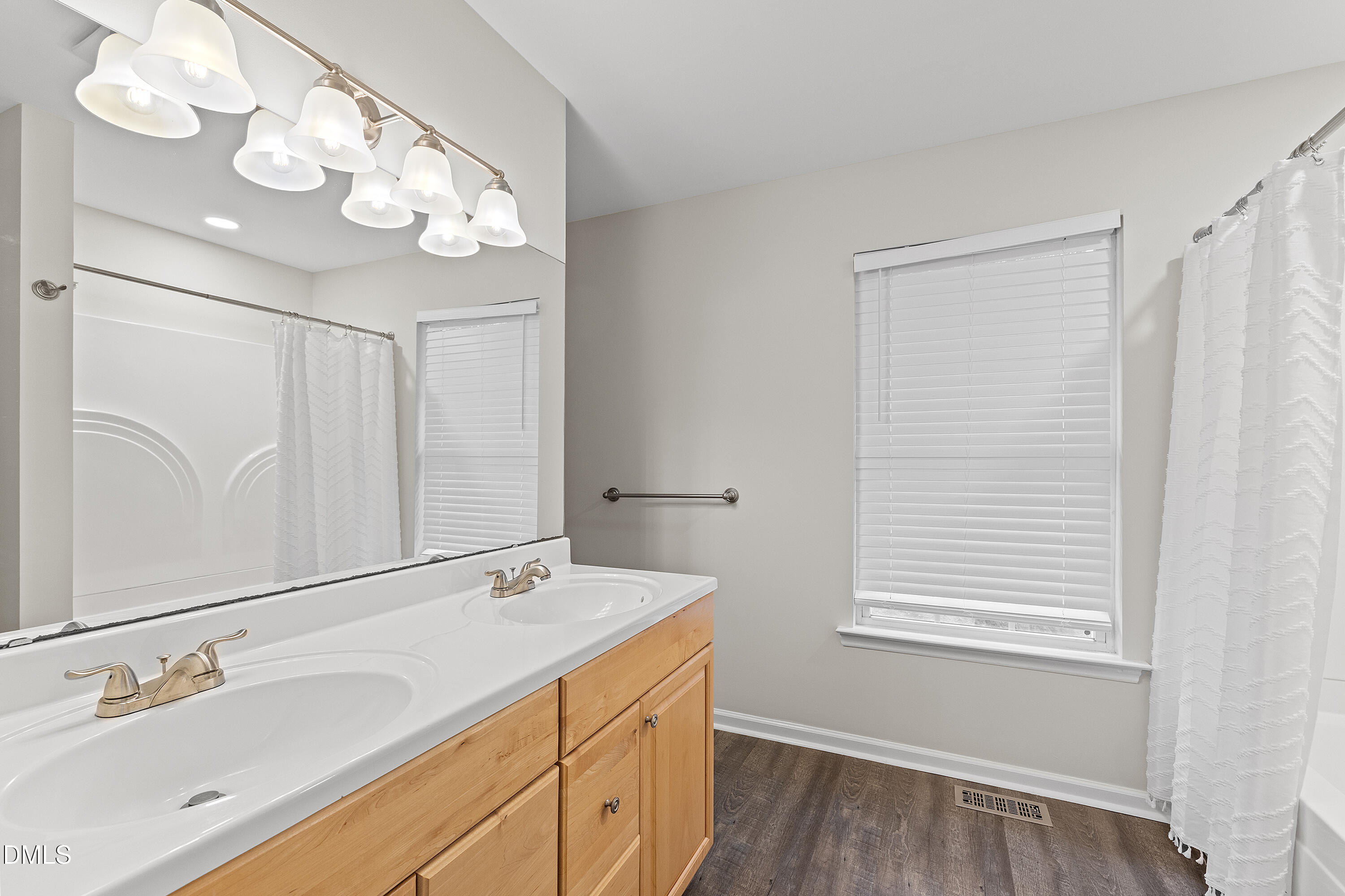7119 Wexford Woods Trail Raleigh, NC 27613 - Photo 28 of 41 a bathroom with a sink vanity and a mirror