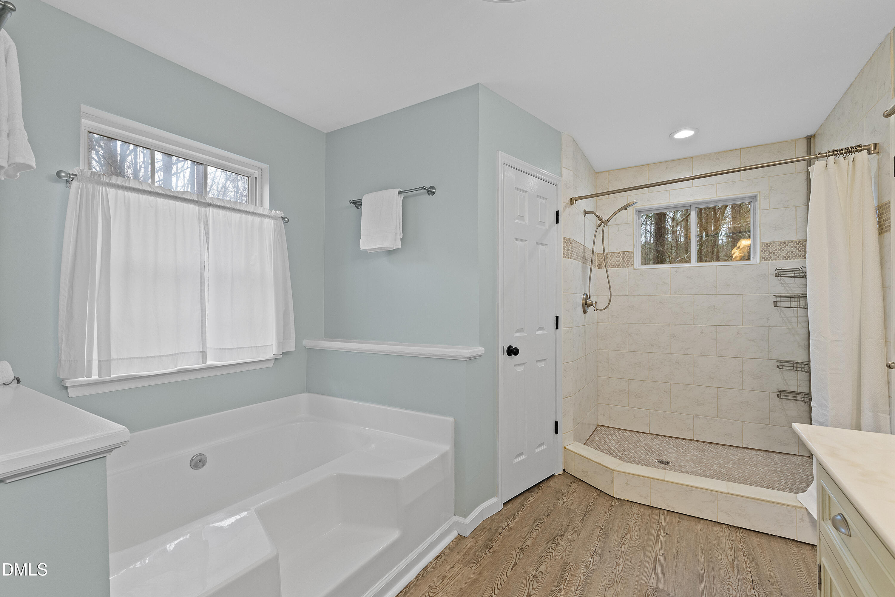 7119 Wexford Woods Trail Raleigh, NC 27613 - Photo 36 of 41 a bathroom with a bathtub and a shower