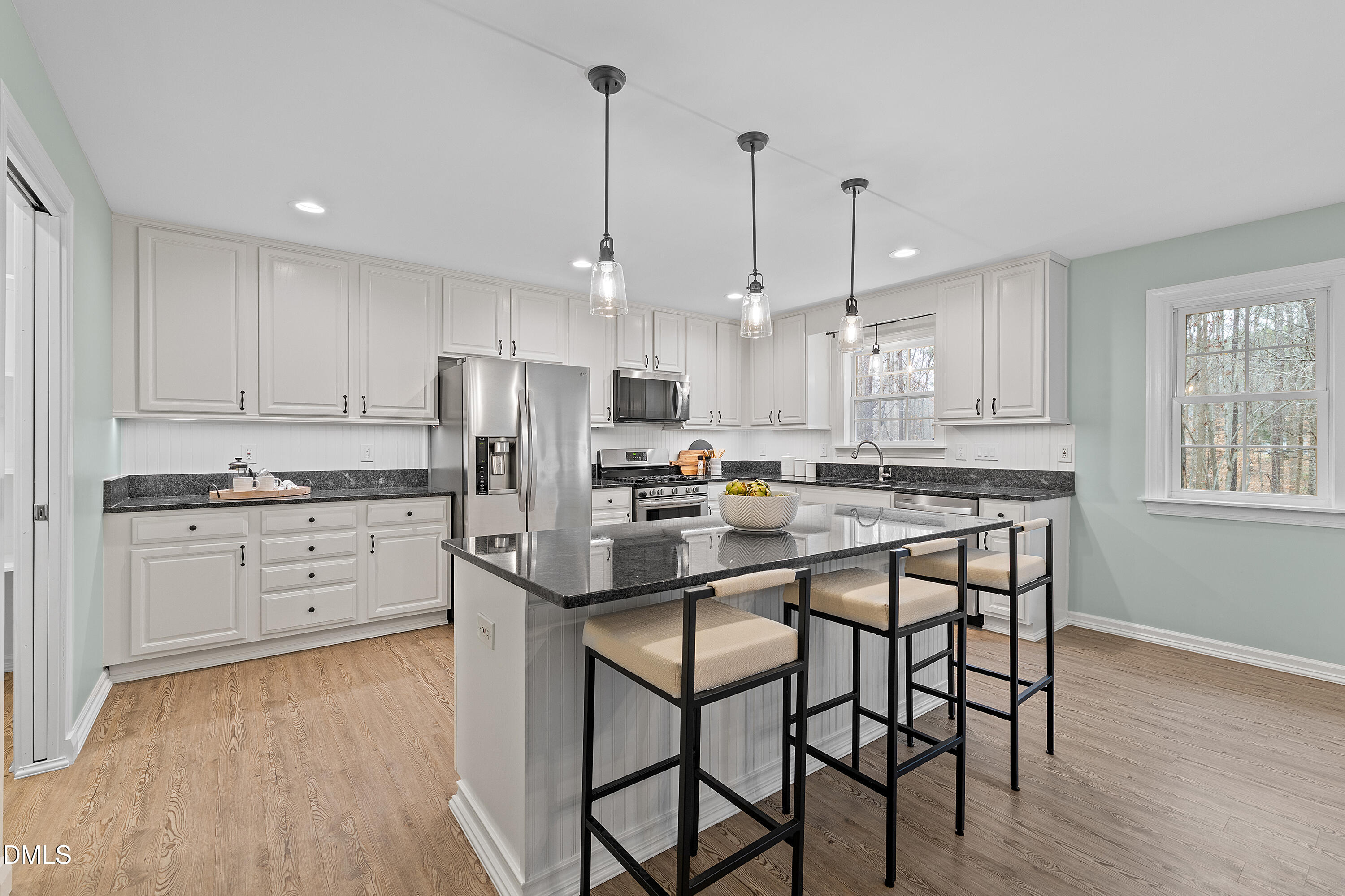 7119 Wexford Woods Trail Raleigh, NC 27613 - Photo 6 of 41 a kitchen with white cabinets stainless steel appliances and a window