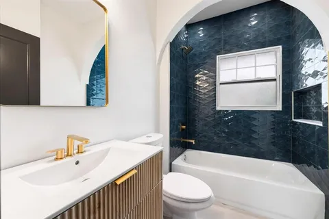 a bathroom with a sink a toilet and bathtub