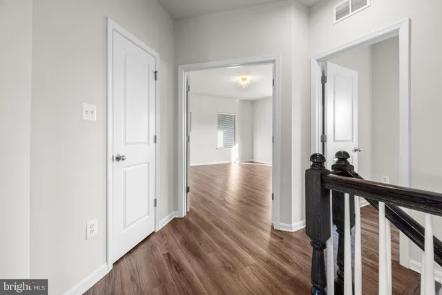 a view of a hallway view with wooden floor and staircase