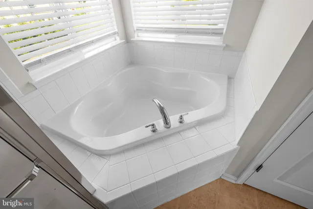a bath tub sitting next to a window