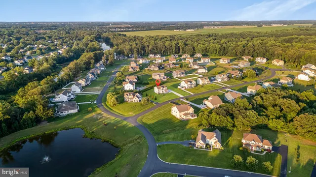 an aerial view of residential houses with outdoor space and swimming pool