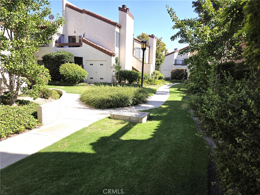 1730 Sinaloa Road, Unit 301 Simi Valley, CA 93065 - Photo 1 of 1 a front view of a house with a yard and green space