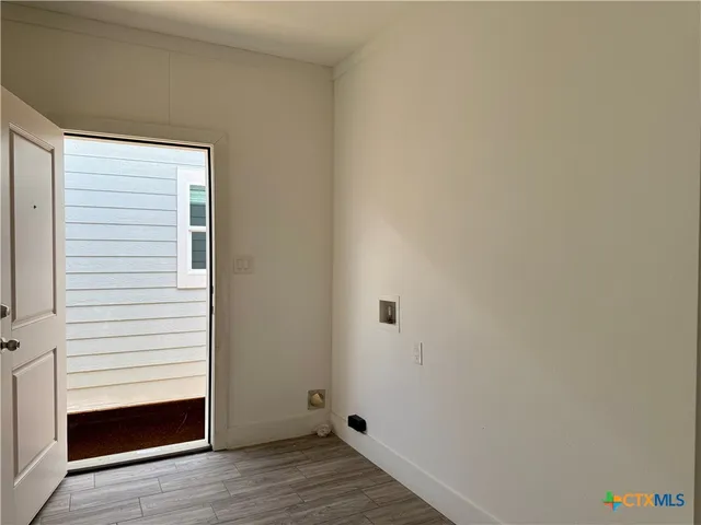 a view of a room with wooden floor