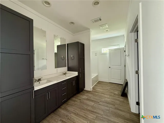 a bathroom with a double vanity sink and mirror