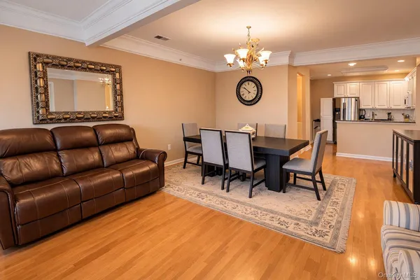 a living room with furniture a lamp a rug and a large window