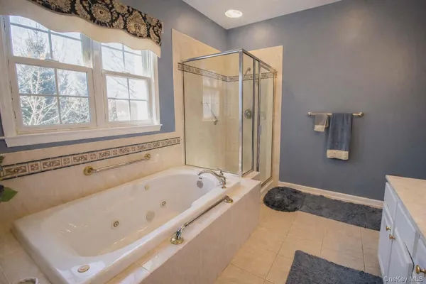 a bathroom with a tub and a window