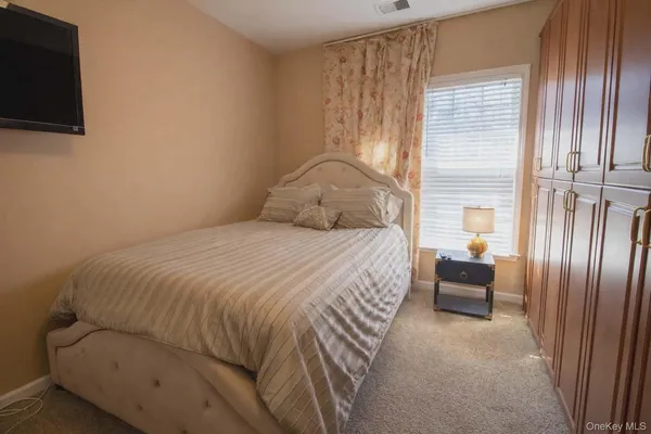 a bedroom with a bed and a television