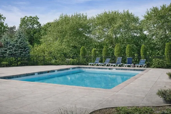 a view of backyard with swimming pool and outdoor seating