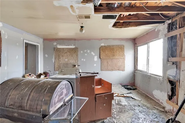a work room with furniture and a fan