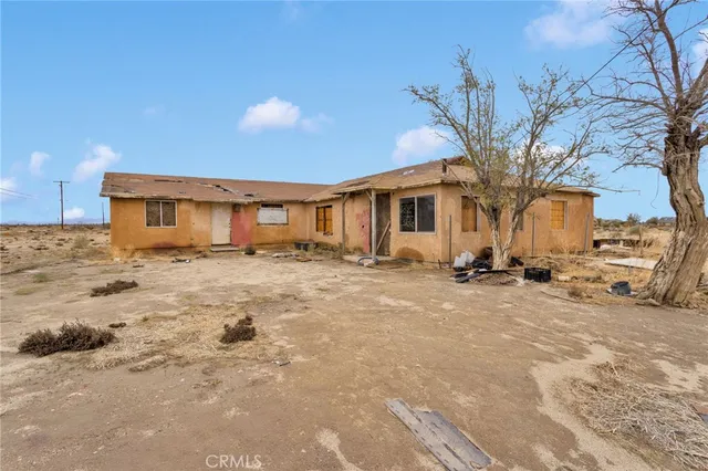 a view of a house with snow on the road