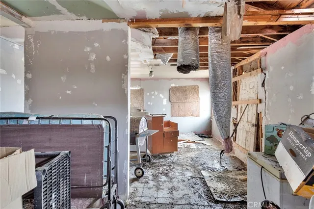 a room with furniture a rug and a chandelier