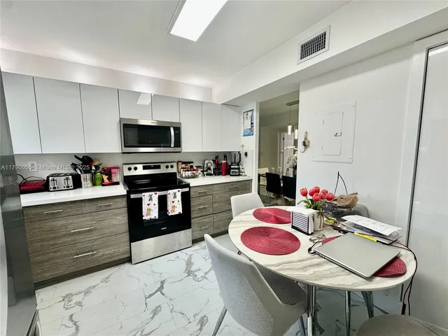 a kitchen with stainless steel appliances kitchen island granite countertop a sink and cabinets