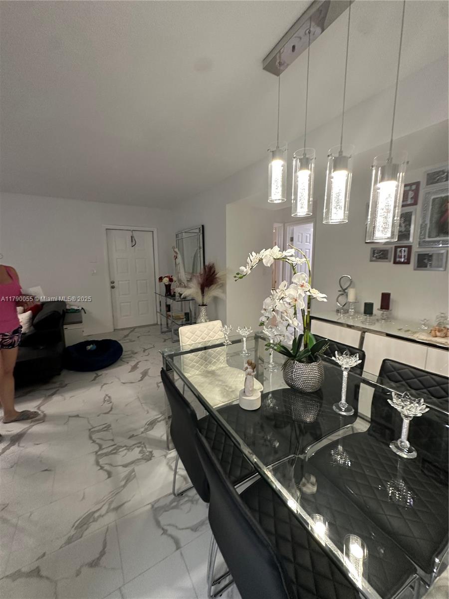 1200 Southwest 113th Terrace, Unit 202 Pembroke Pines, FL 33025 - Photo 12 of 14 a kitchen with a stove a sink and chandelier