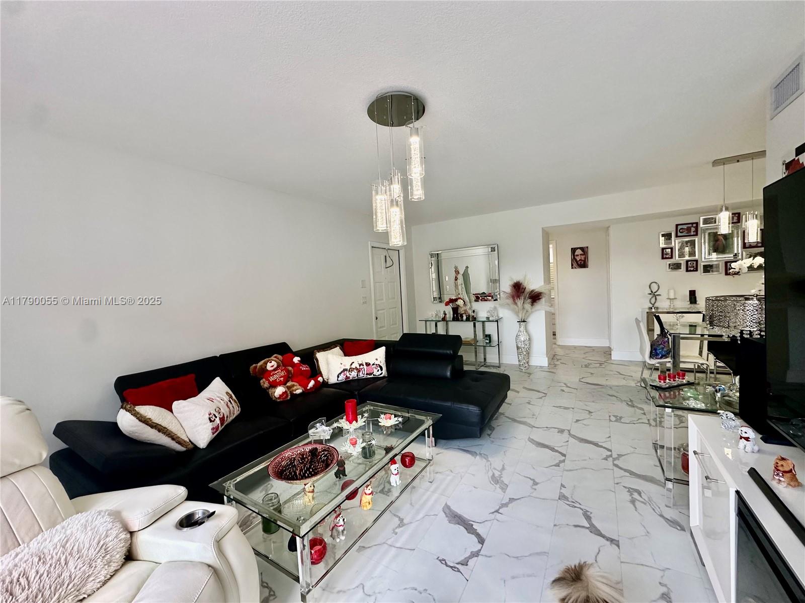 1200 Southwest 113th Terrace, Unit 202 Pembroke Pines, FL 33025 - Photo 3 of 14 a living room with furniture chess board and a couch