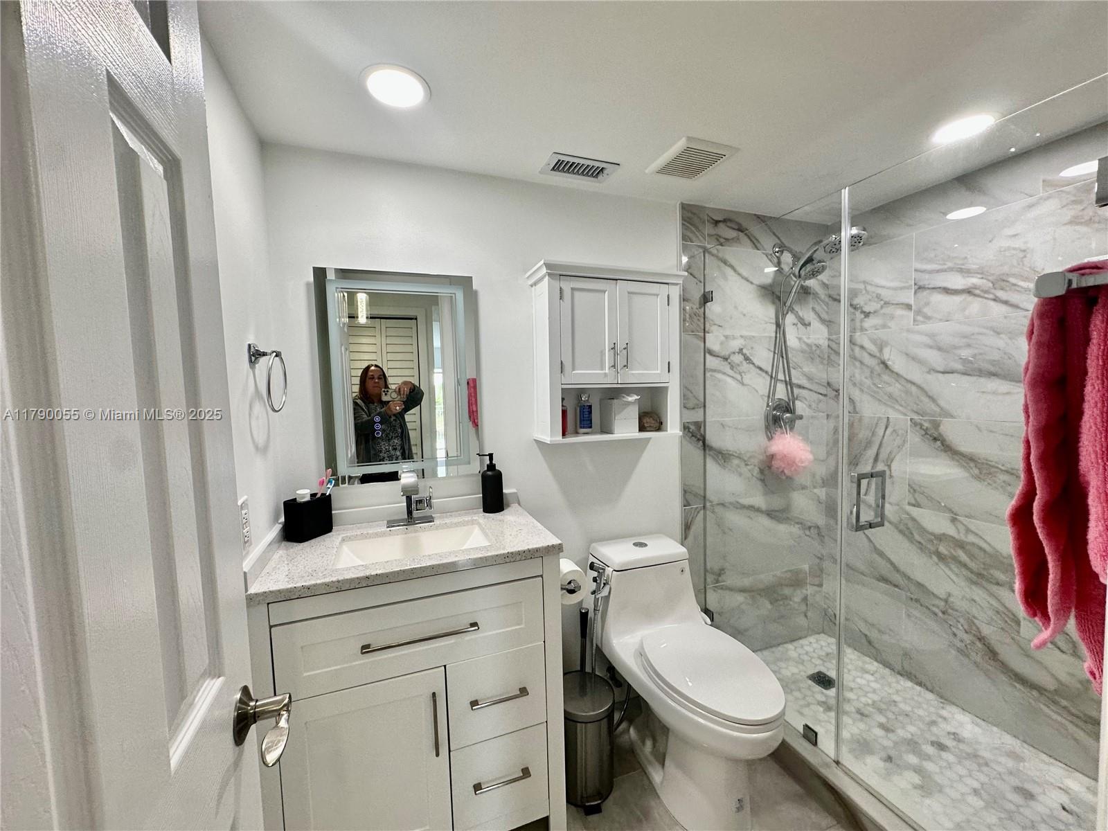 1200 Southwest 113th Terrace, Unit 202 Pembroke Pines, FL 33025 - Photo 5 of 14 a bathroom with a sink toilet vanity and shower