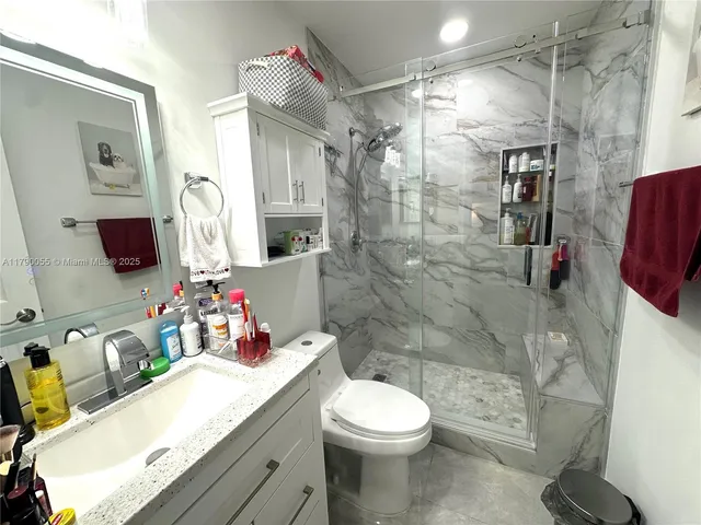 a bathroom with a sink toilet and shower