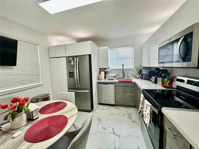 a kitchen with a refrigerator stove and sink