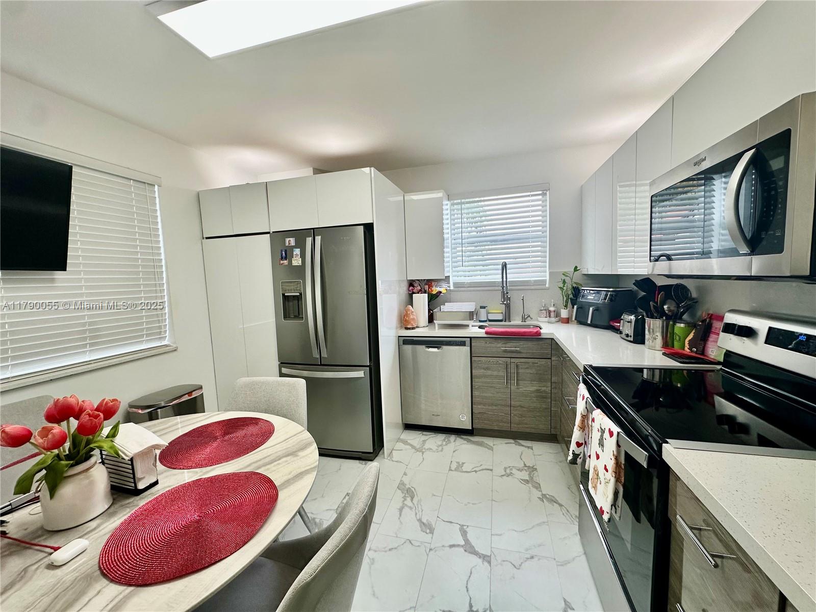 1200 Southwest 113th Terrace, Unit 202 Pembroke Pines, FL 33025 - Photo 10 of 14 a kitchen with a refrigerator stove and sink