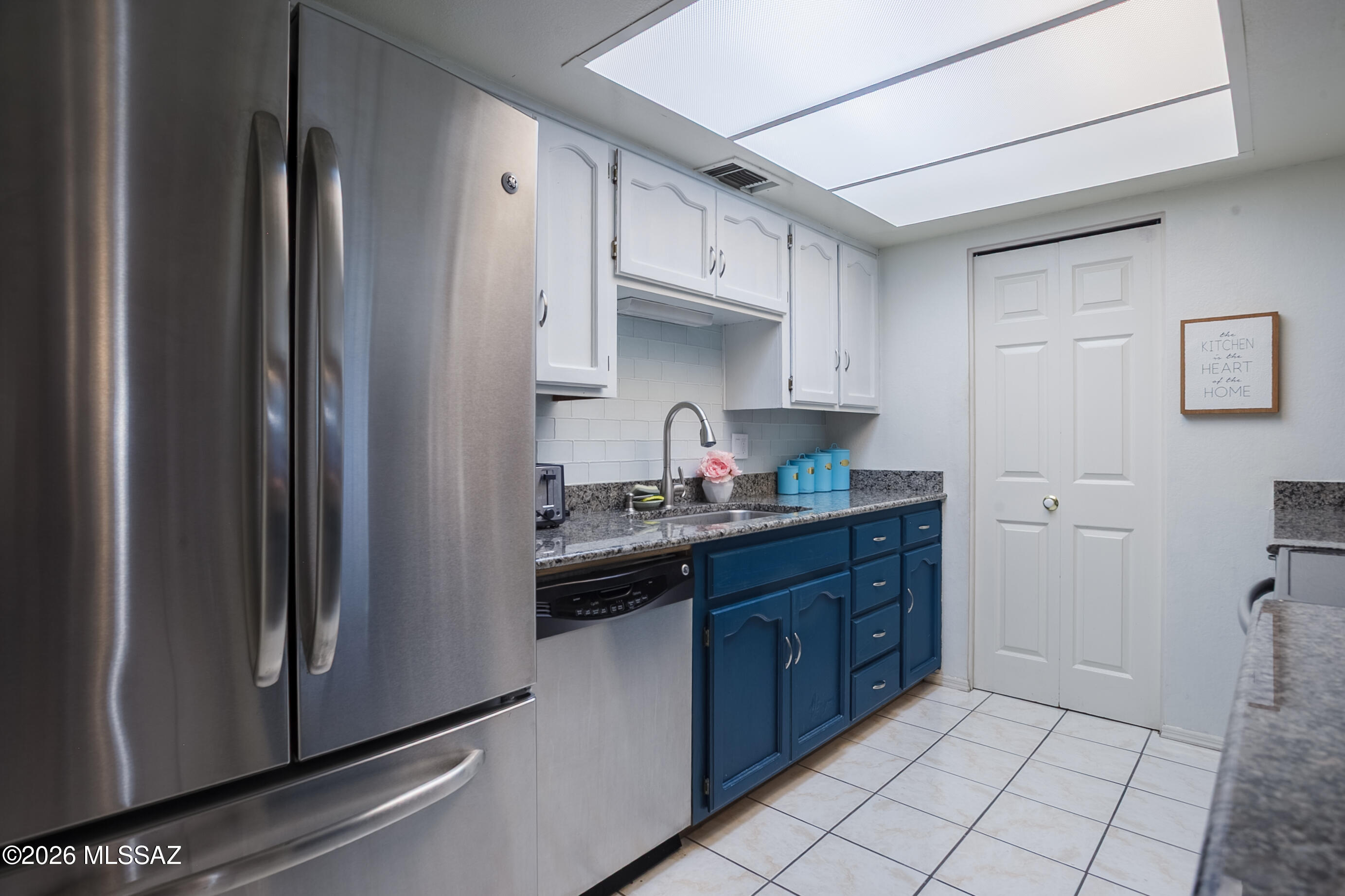 1200 East River Road, Unit B27 Tucson, AZ 85718 - Photo 16 of 40 a kitchen with stainless steel appliances granite countertop a refrigerator and a sink