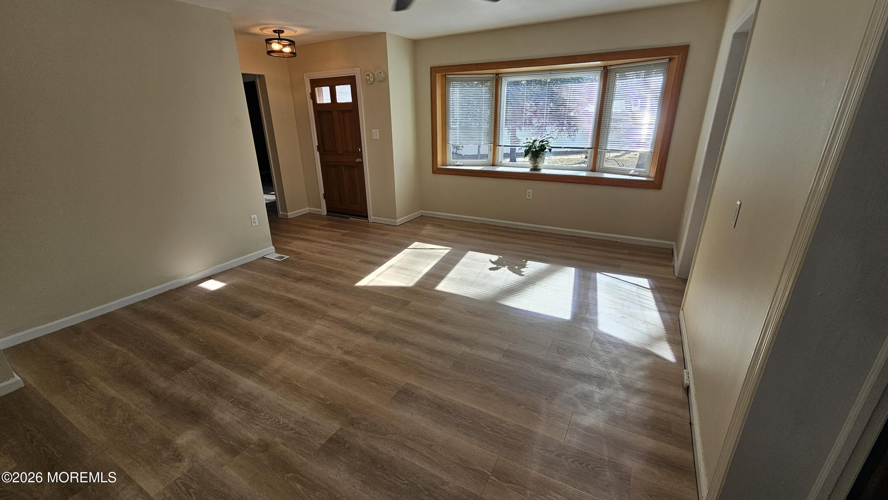 12 Anderson Drive Howell, NJ 07731 - Photo 11 of 26 a view of an empty room with wooden floor and a window