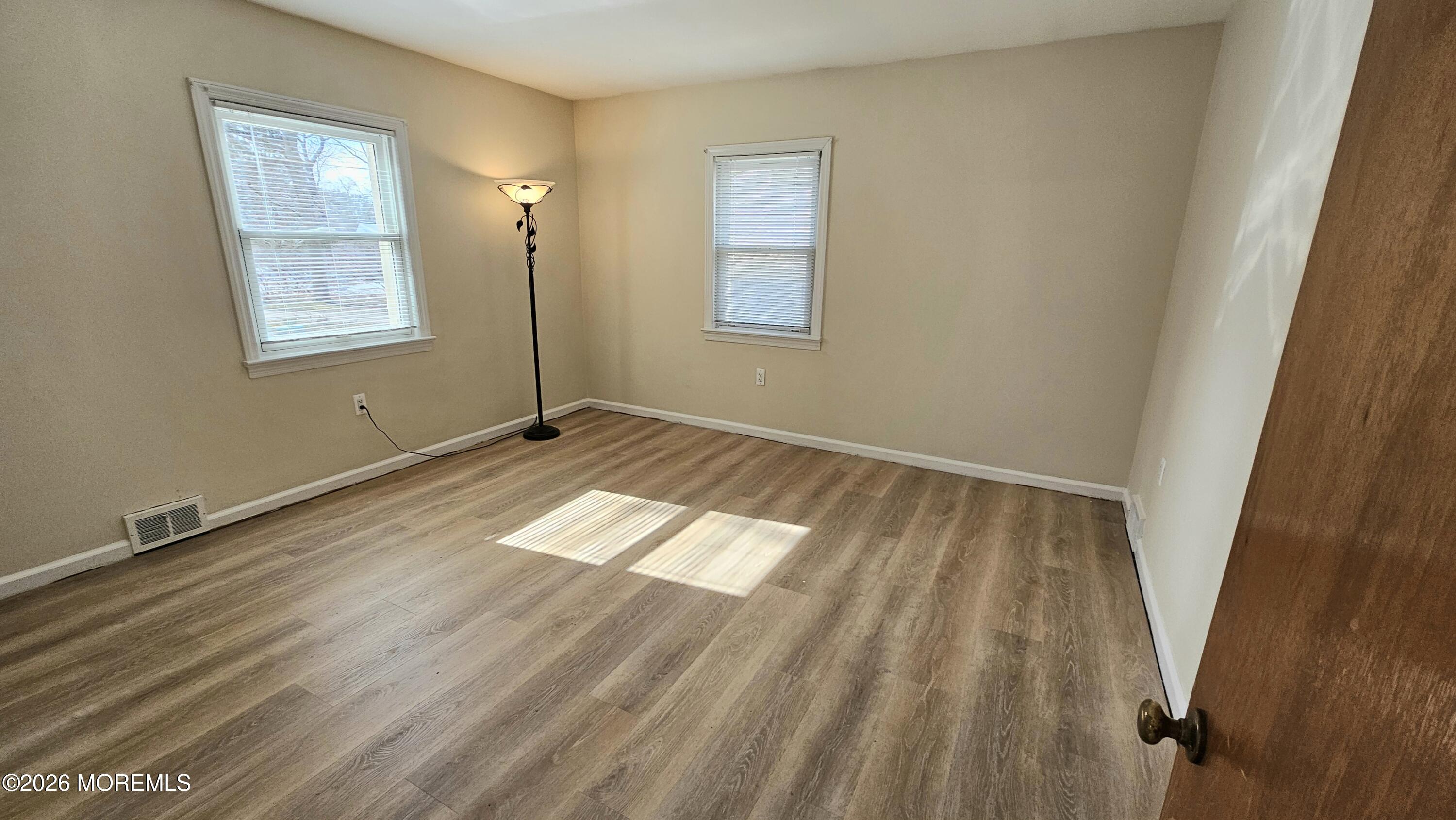 12 Anderson Drive Howell, NJ 07731 - Photo 14 of 26 a view of empty room with wooden floor and fan