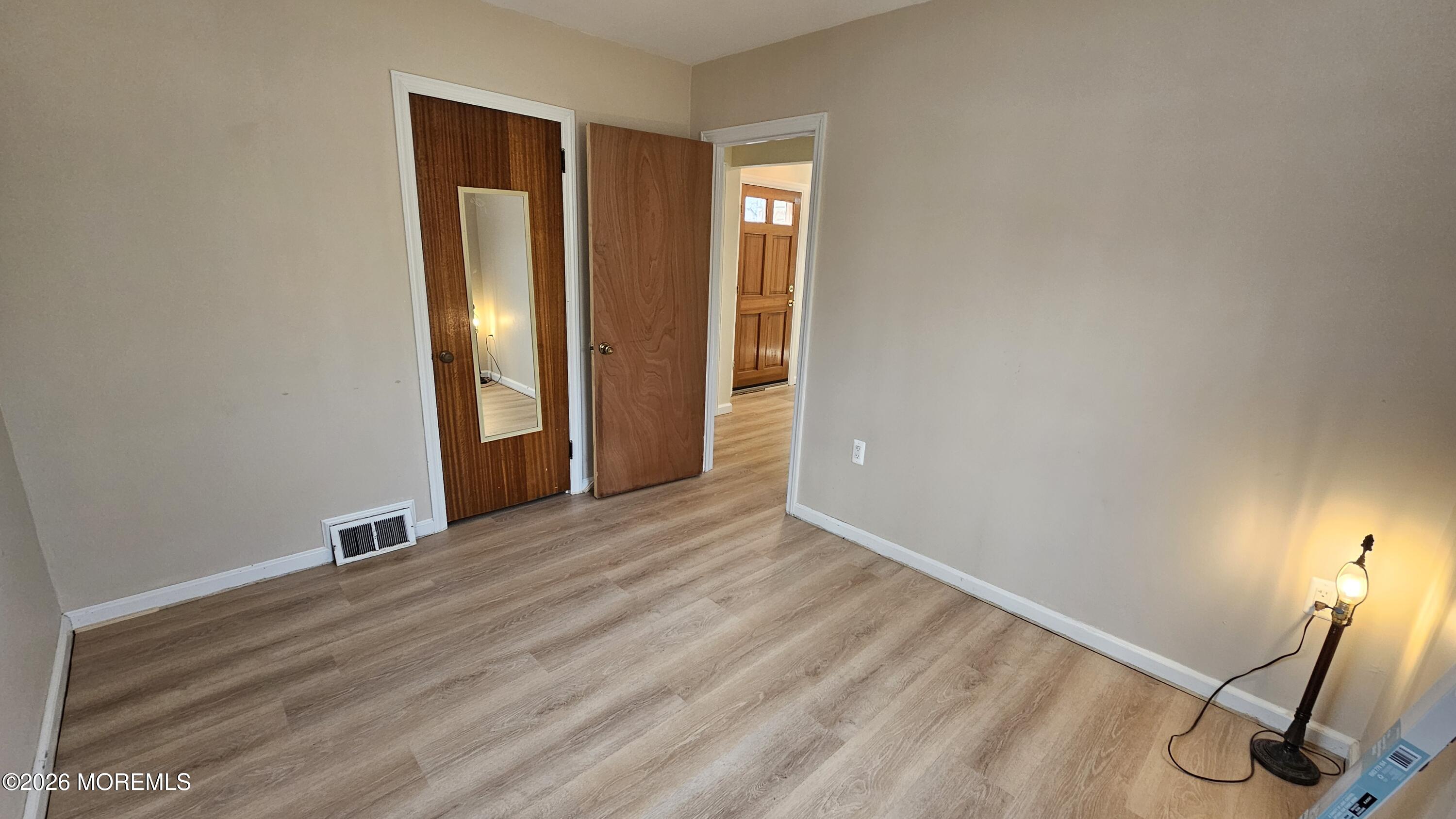 12 Anderson Drive Howell, NJ 07731 - Photo 19 of 26 a view of an empty room with wooden floor