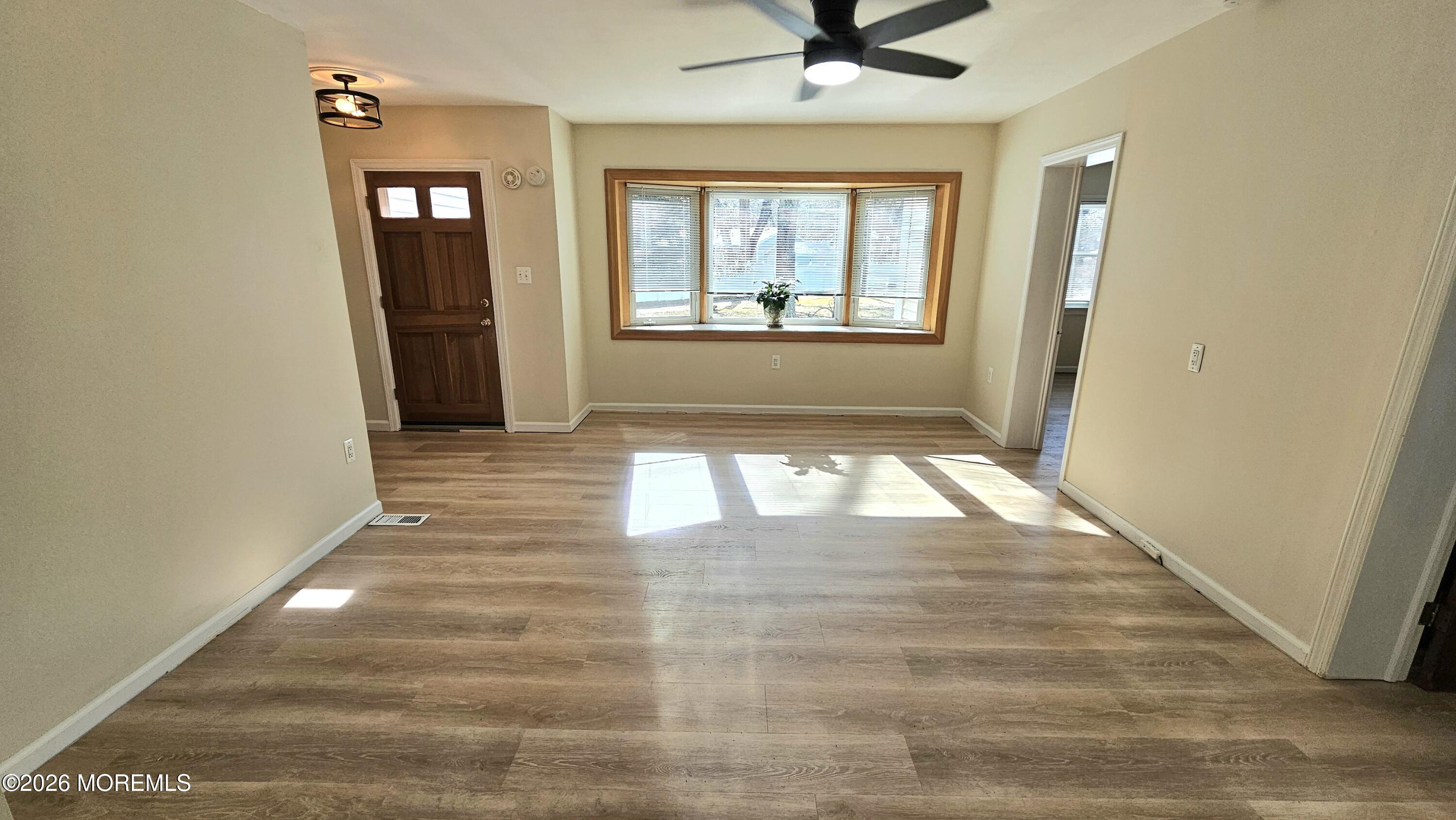 12 Anderson Drive Howell, NJ 07731 - Photo 10 of 26 wooden floor in an empty room with a window