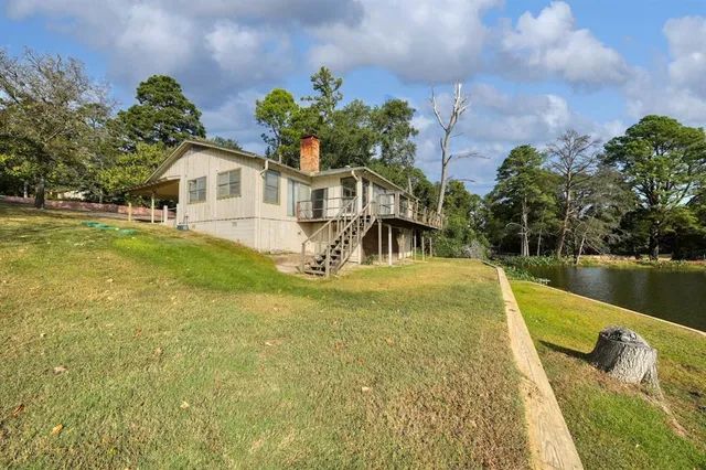 a view of a house with pool and a yard