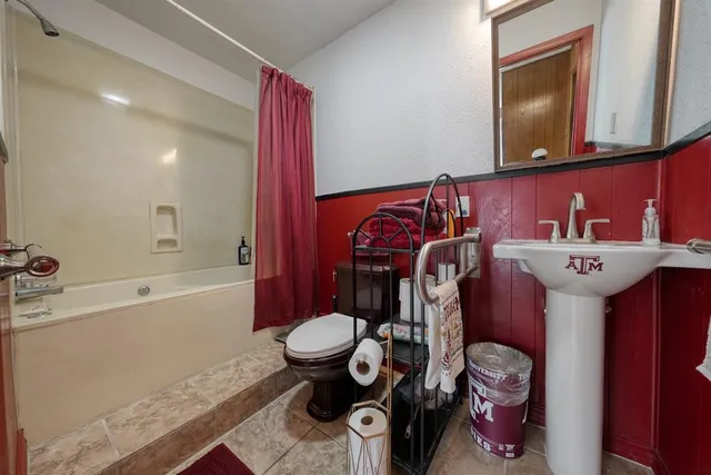 a bathroom with a sink mirror vanity and toilet