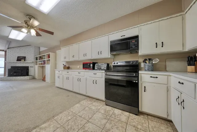 a kitchen with cabinets stainless steel appliances and a counter top space