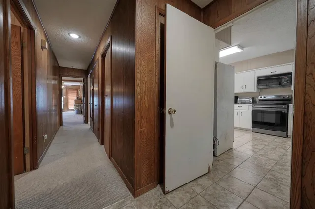 a view of a hallway with stainless steel appliances granite countertop lots of counter top space