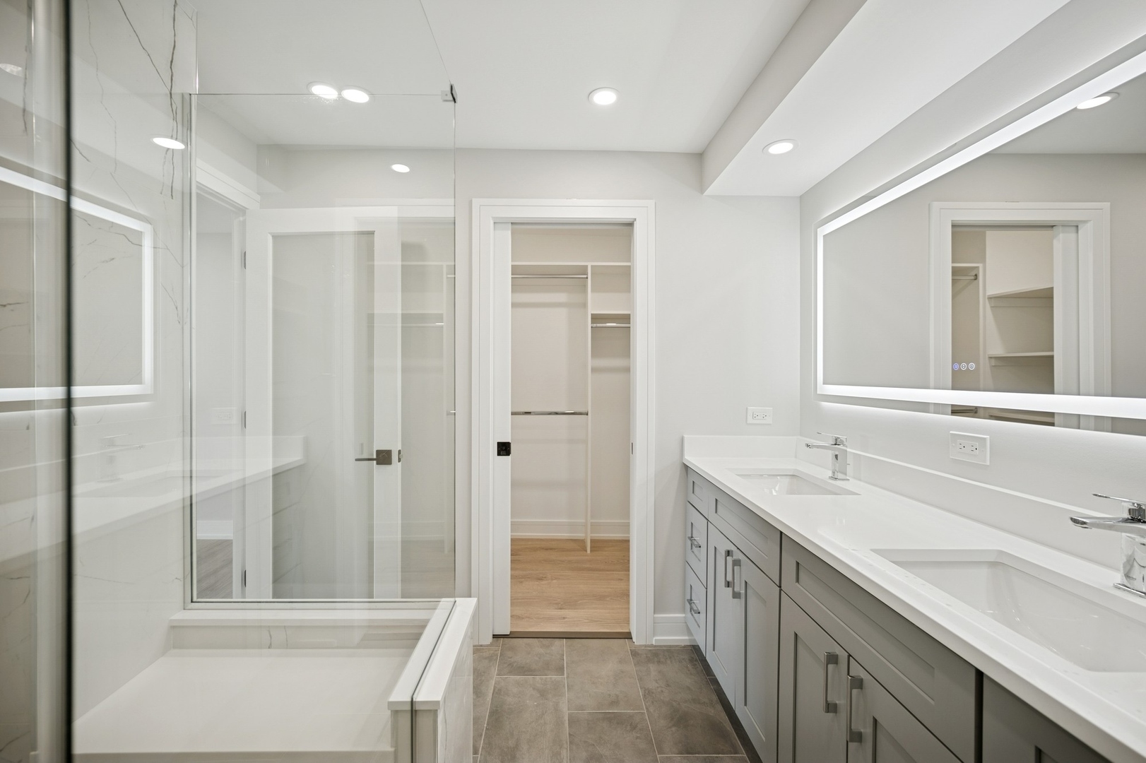 3851 Mission Hills Road, Unit 409 Northbrook, IL 60062 - Photo 11 of 19 a bathroom with a double vanity sink and a mirror